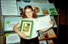 Елизавета Рассоха с подарками от Партии зелёных. Книгу Джона Мильтона «Потерянный и возвращённый рай» девочка ещё не читала (фото из архива Наталии Рассохи)